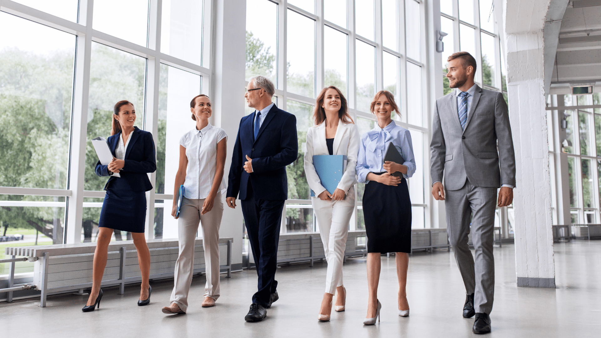 group of business people walking in suits